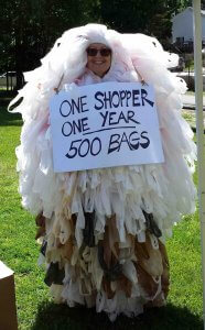 Reduce: man in suit made of 500 plastic bags