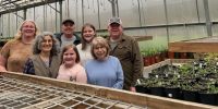 greenhouse volunteers with seedlings